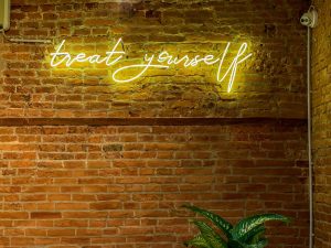 'treat yourself' in neon